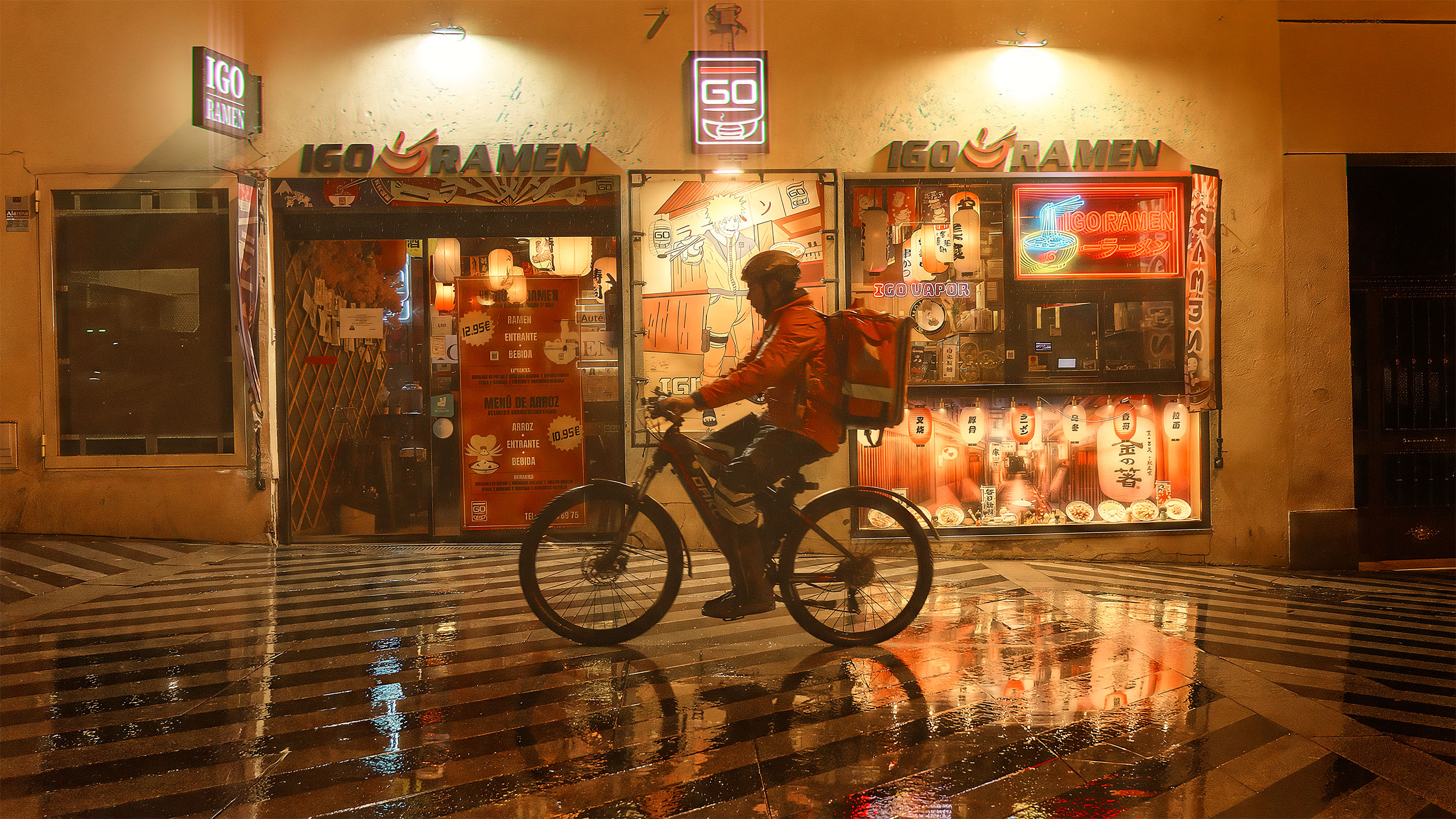 Delivery cyclist passing Igo Ramen restaurant at night in Madrid, warm orange neon light reflecting on wet street