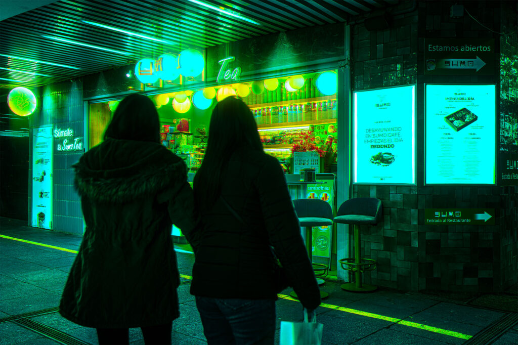 Two silhouettes walking towards Sumo Tea, a glowing green tea shop at night in Madrid, Spain, neon lanterns and illuminated signage, cyberpunk atmosphere