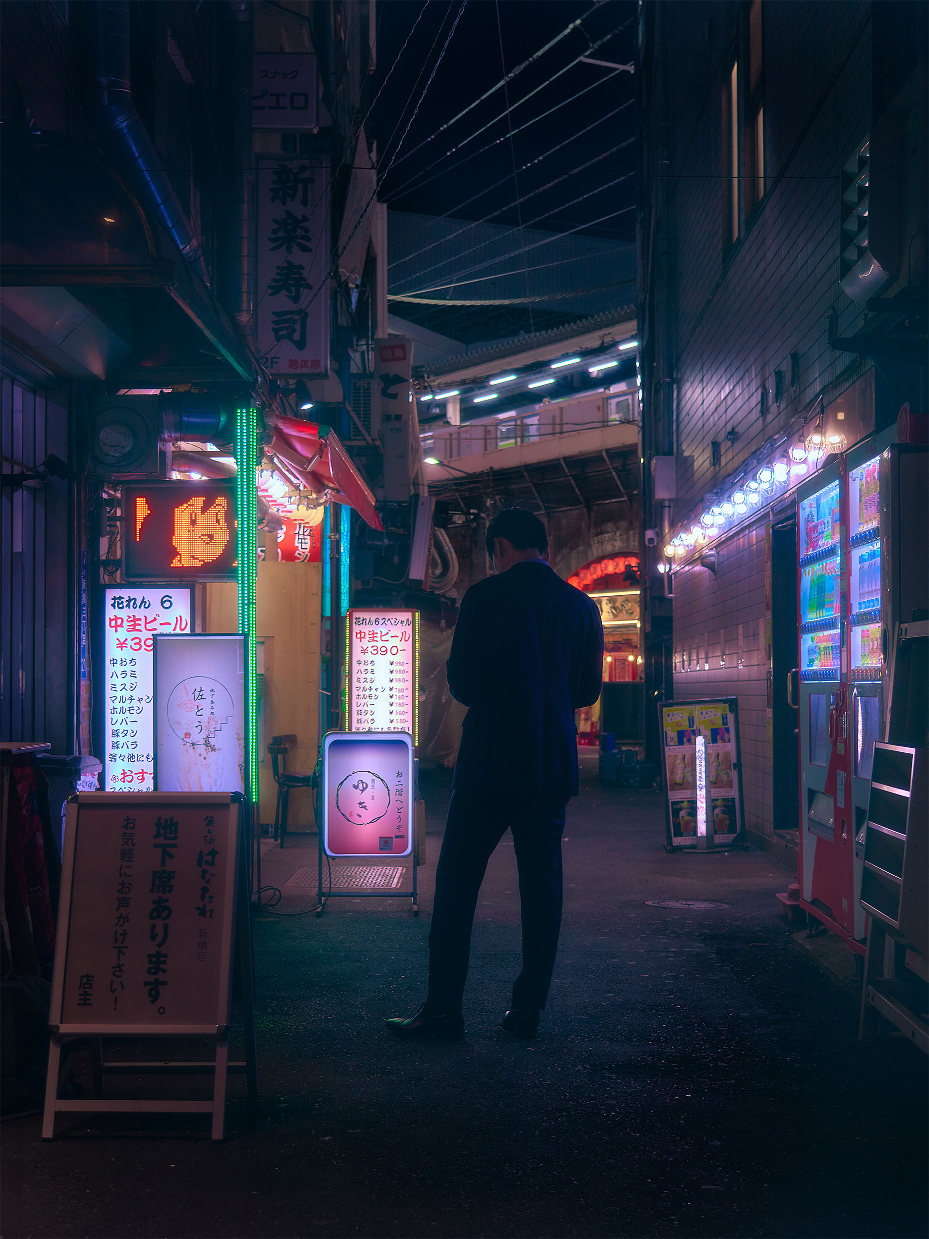 Lone figure pausing on a street at night in Shimbashi, Tokyo, Japan, warm neon light from surrounding shops, cyberpunk street photography